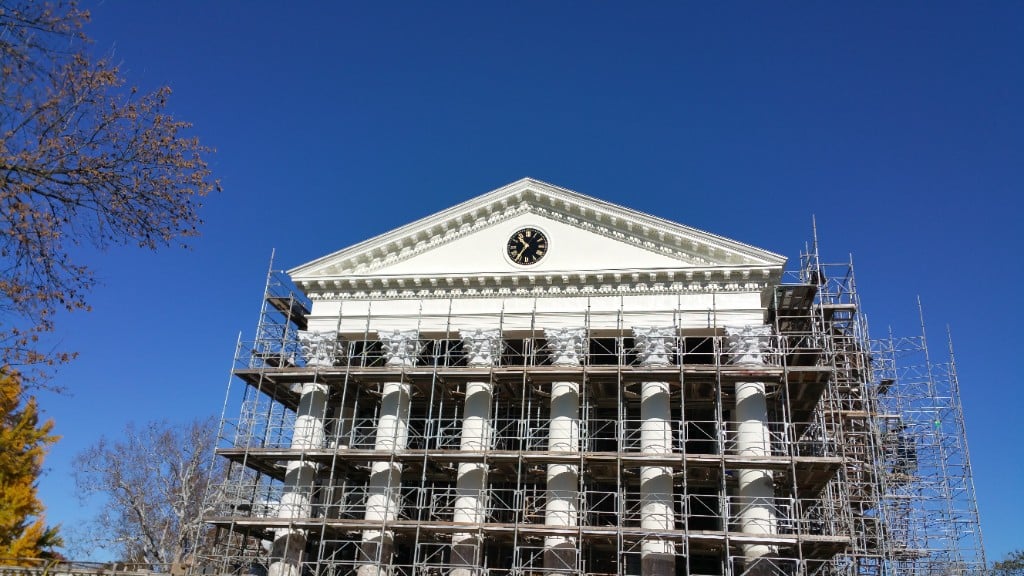 Neoclassical courthouse under full scaffold during slate roof restoration
